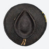 Top view of a Valeria Andino Handmade Straw Hat, its Classic cowboy shape in black with hand dyed silk trimmings, stones and gold jewelry